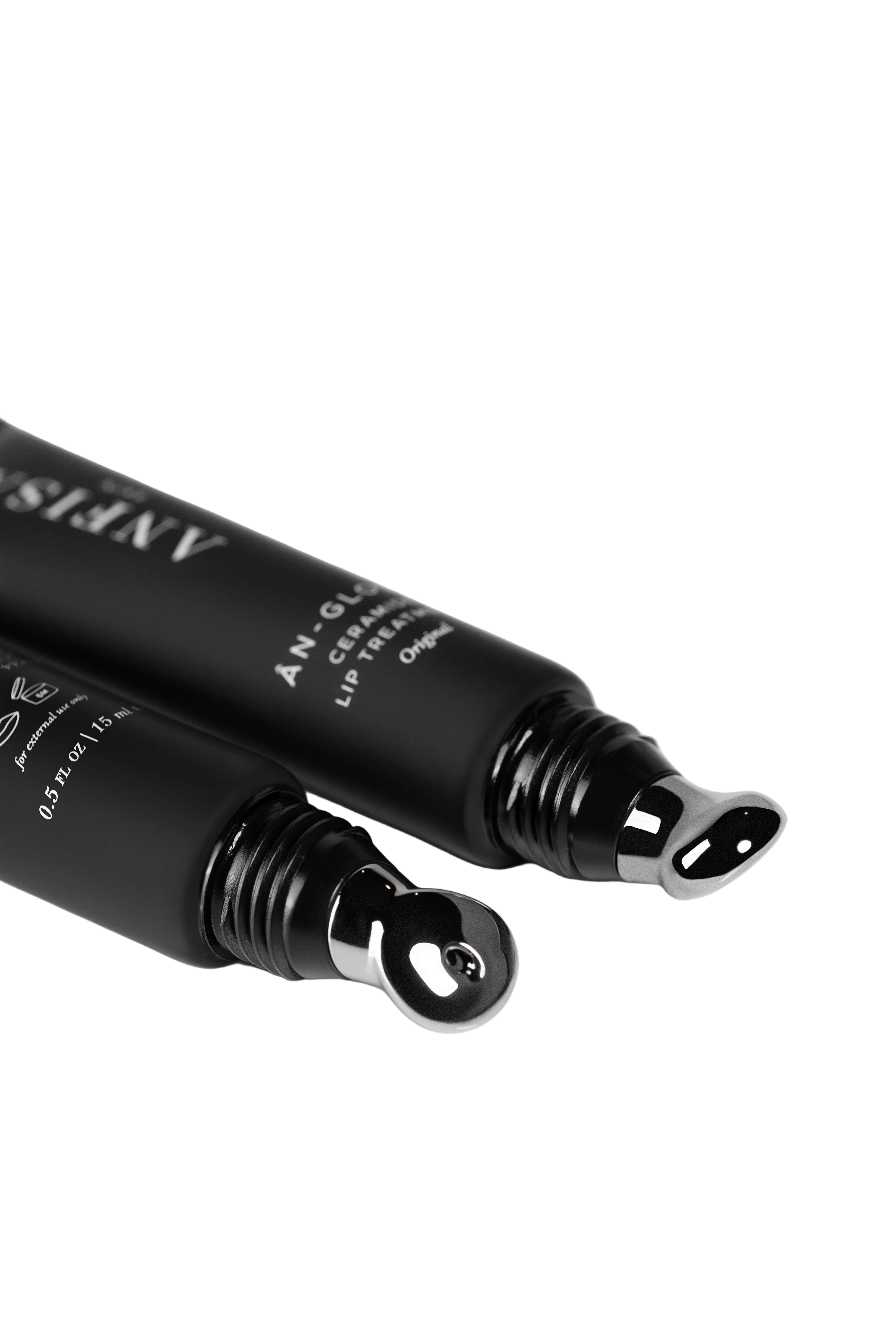 Two black lip products with visible branding on a white background