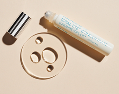 Skincare product with applicator on a beige background